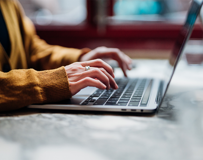 Web content specialist women typing on laptop for client