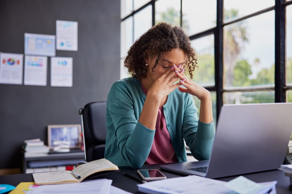 A woman is frustrated at her laptop as she looks for digital marketing services for small businesses